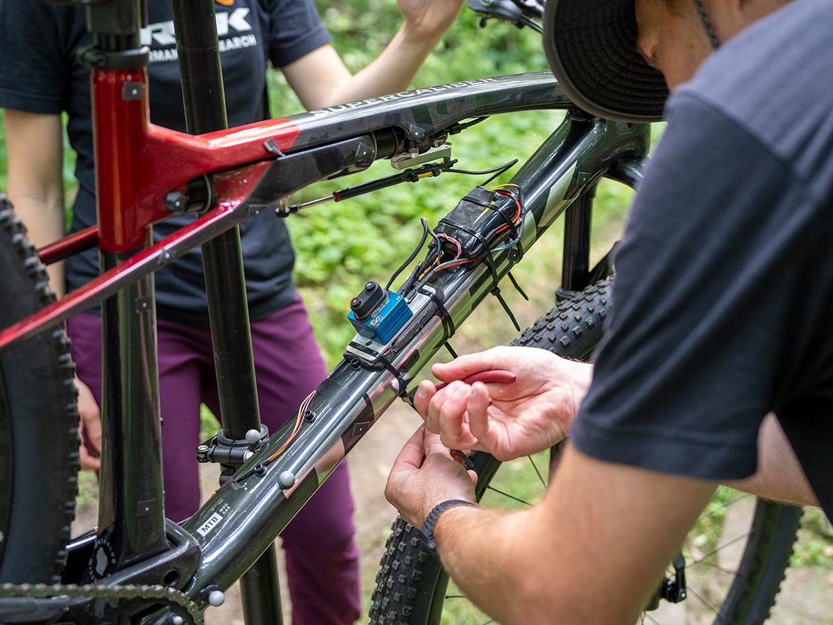 Cyclist wearing a helmet while engineering the speed of a prototype bike on trail