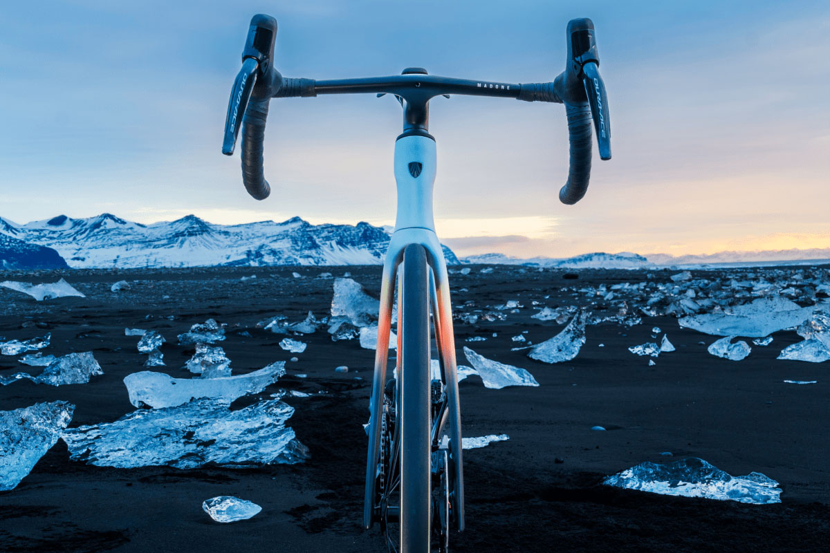 Project One ICON: Crystalline Arctic Haze on a beach with chunks of ice and snow-covered mountains in background