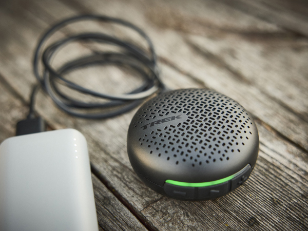 BellBeats sitting on table while plugged into USB charging cable