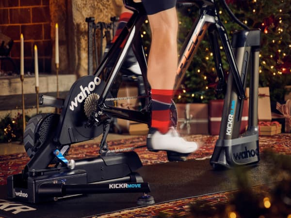 Cyclist riding a Wahoo indoor trainer in a living room decorated for the Holidays