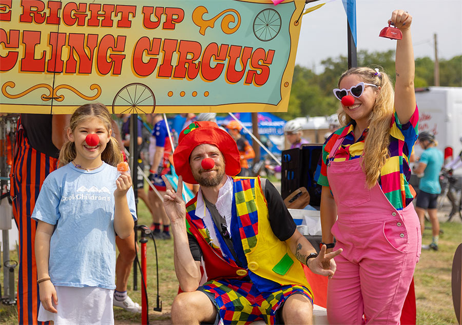 Participant and volunteers wearing red clown noses while smiling