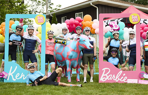 Participants wearing helmets while posing at Barbie rest stop from past Trek 100 event